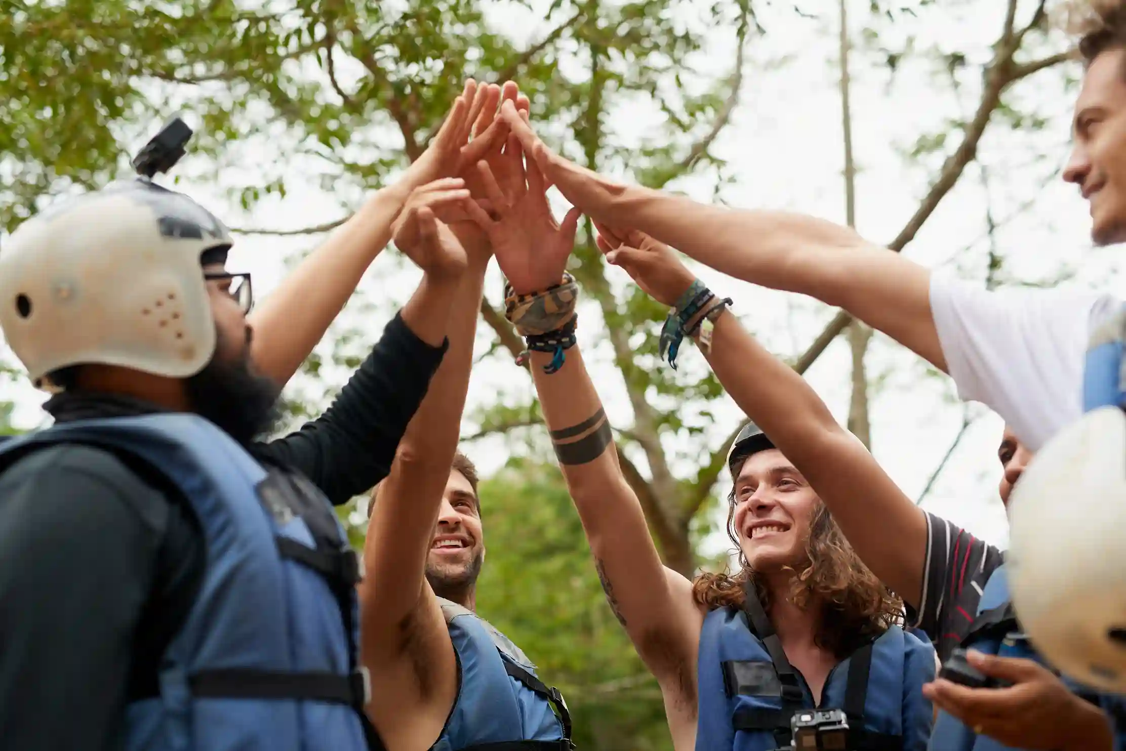 Team Building outdoor – Activité nautique et cohésion d’équipe Équipe se félicitant avant une activité nautique outdoor lors d’un team building